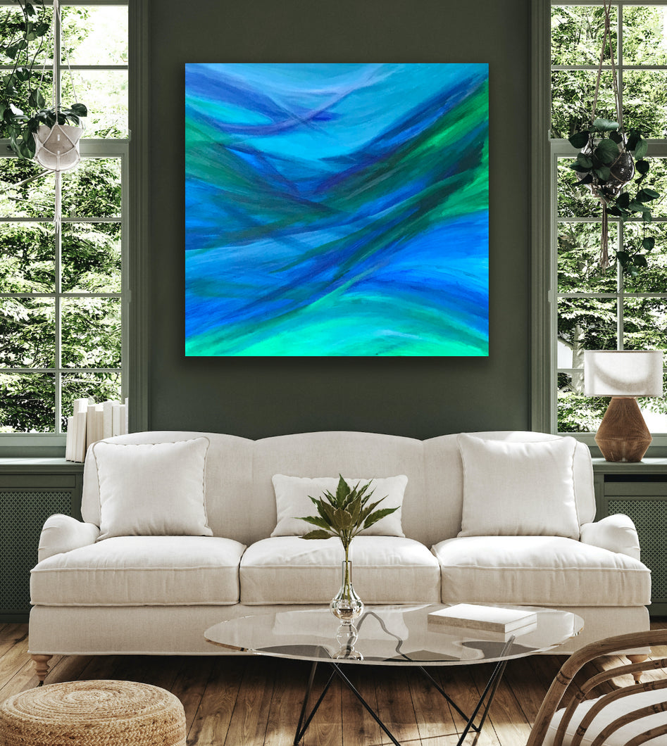Modern living room with a white sofa, abstract painting, and decorative items.
