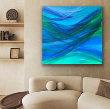 Load image into Gallery viewer, Abstract painting of blue and green on a wall above a beige sofa.