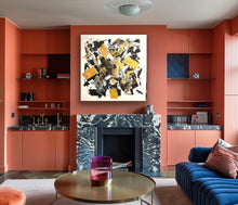Load image into Gallery viewer, Modern living room with orange walls, a marble fireplace, and abstract art.