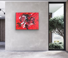 Load image into Gallery viewer, Abstract red original painting on a gray wall with a view of greenery outside.