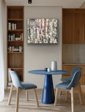 Load image into Gallery viewer, Modern dining area with blue table and chairs, bookshelf, and abstract painting.