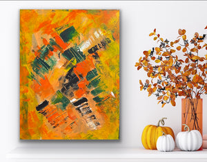 Abstract painting with orange, yellow, and black colors on a wall with decorative pumpkins and branches.