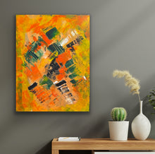 Load image into Gallery viewer, Abstract painting with orange, green, and black colors on a gray wall above a wooden table with a cactus and vase.