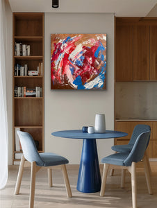Dining area with a blue table and chairs, wooden bookshelf, and abstract painting on the wall.