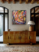Load image into Gallery viewer, Wooden sideboard with a colorful abstract painting above it in a room with brick walls and large windows.